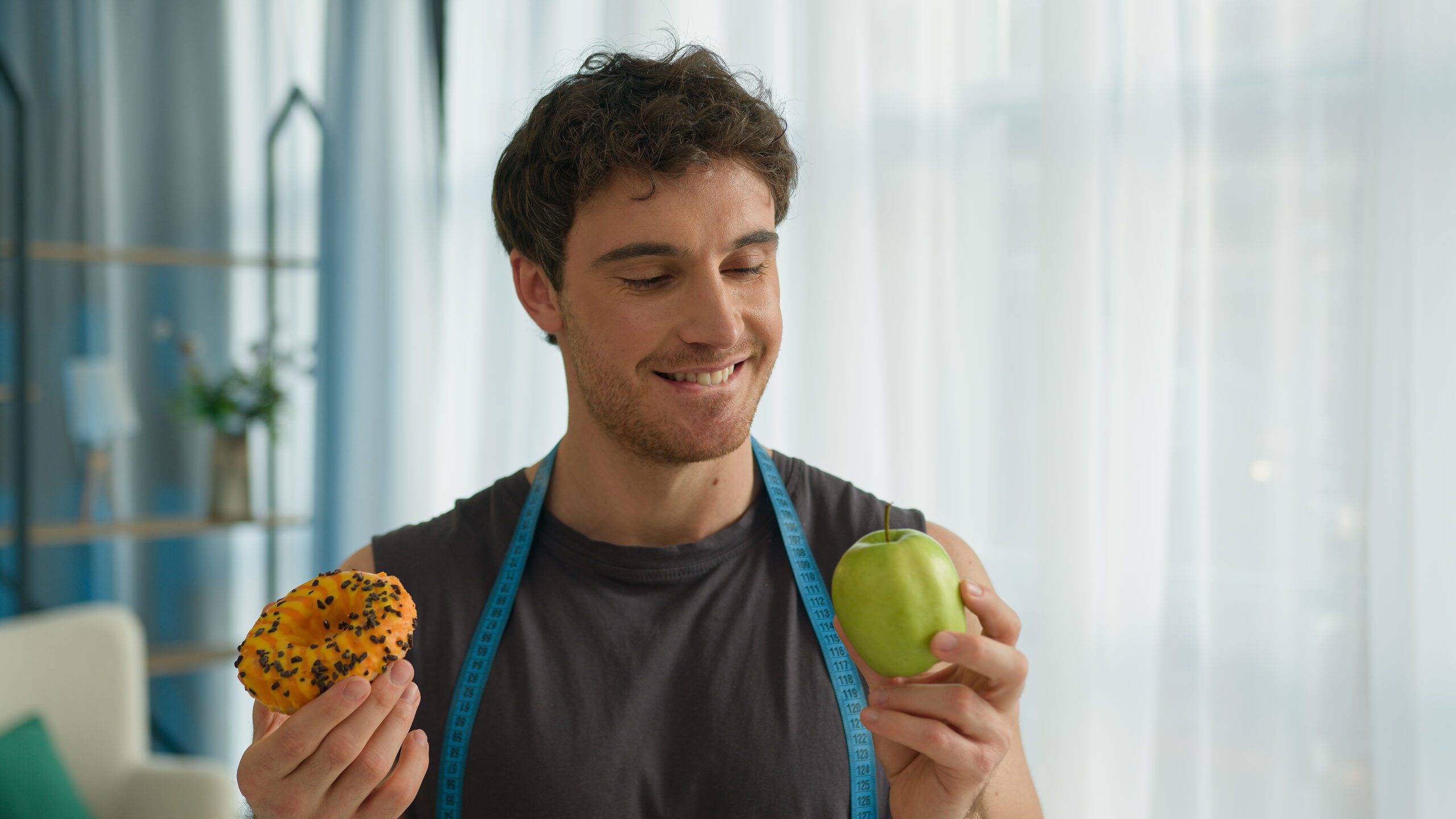 team member David Hobs holding doughnut and apple