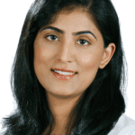 Dr. Salma In white scrub and white background