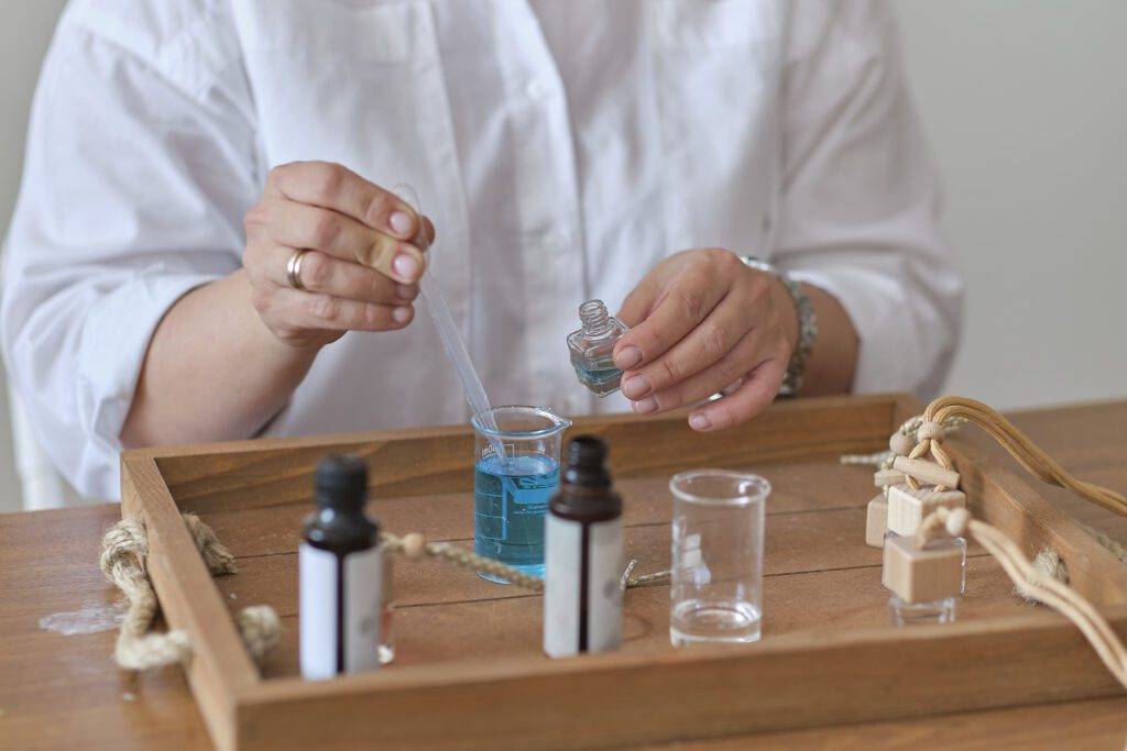 Close-up of a pipette homeopathy medicine, woman pouring medicine in bottle. 