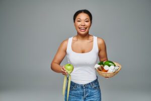 Weight Loss Revolution page showcasing a female model holding apple and measuring tape on one end and basket full of medicines on other hand